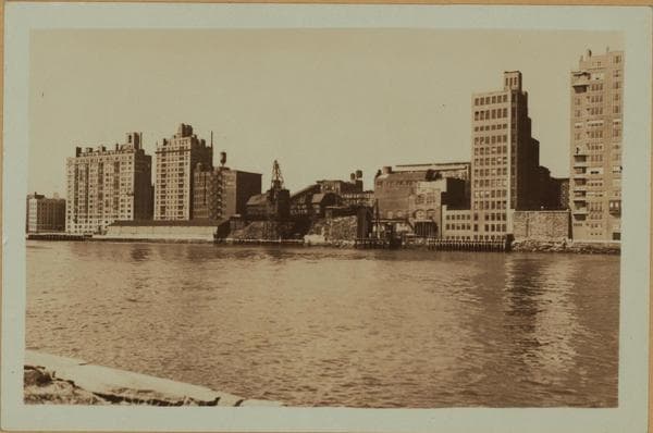 East River - Shore and skyline of Manhattan between East 78th and 89th Streets - Queensborough Bridge - [Brearly School; Yorkgate; Yorkville Ice Sales Corporation.], 1933–1935