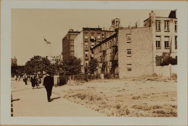 Manhattan: 6th Avenue - Minetta Street. Sixth Avenue, east side, north from Minetta Street, showing grassy plots upon which were buildings prior to the extension of Sixth Avenue, from Minetta Lane south to Church Street. The elongated 3-story structure on the right, that apparently faces Sixth Avenue is No. 2 Minetta Lane. Minetta Place, an enclosed Court in the center of this block formerly was in the foreground; the northern extremity of which is shown enclosed by a fence in views 2 (middle) and 3 (right)., 1937-09-18