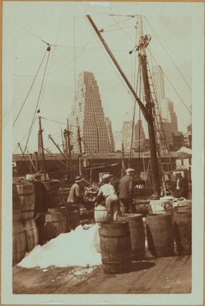 Fulton fish market docks in Manhattan - [Packing fish into barrels.], 1934