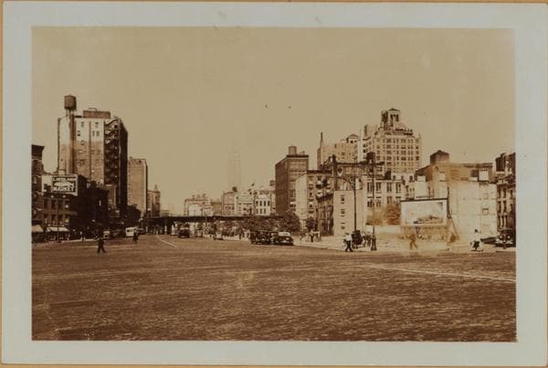 Manhattan: 6th Avenue - Minetta Street. Sixth Avenue, north from Minetta Street (right) and showing empty lots lining the east side of same. These were left when this southern extension of the Avenue was projected. The Sixth Avenue Elevated is seen making an eastward turn on West 3rd Street. In the distance appears the Empire State Building. This set of 3 views shows details of the same area., 1937-09-18