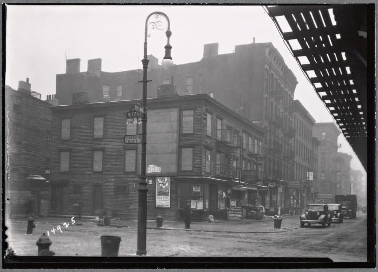 Vacant wood frame tenement with storefronts; Bishop's crook lamp: 9th Ave. - W. 17th St., Manhattan, 1935–1936