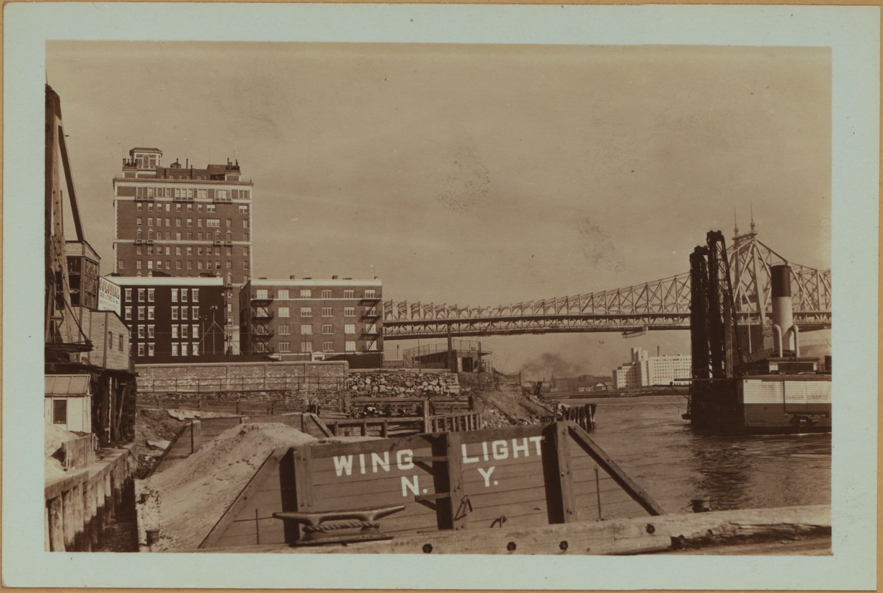 East River - Shore and skyline of Manhattan from East 53rd Street - Williamsburg and Queensborough Bridges - [Colonial Sand and Stone Company.]