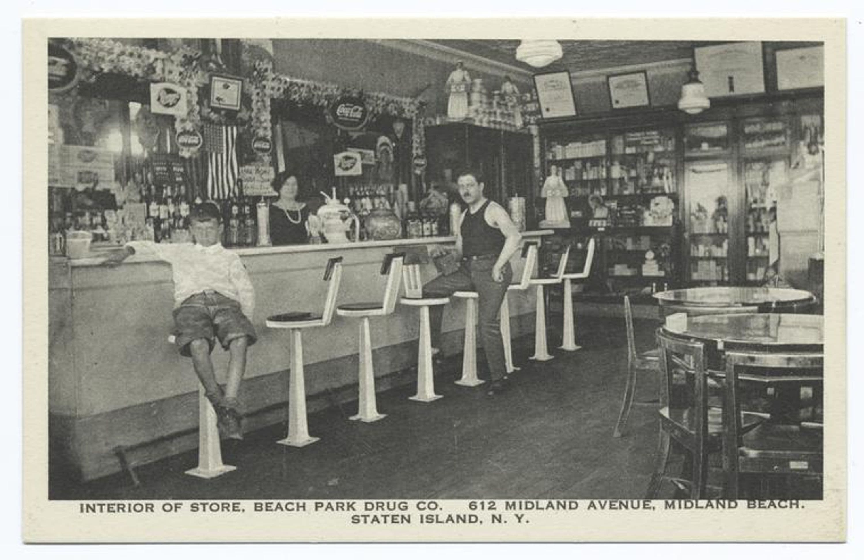 Interior of Store, Beach Park Drug Co. 612 Midland Avenue, Midland Beach, Staten Island, N.Y. [wonderful interior of soda fountain and people at the counter, Coca Cola and Breyers signs, narrow white border around.]