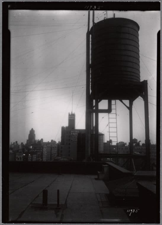 Water tower; view of Hotel Paris (West End Ave & 97th St.) in distance: Manhattan