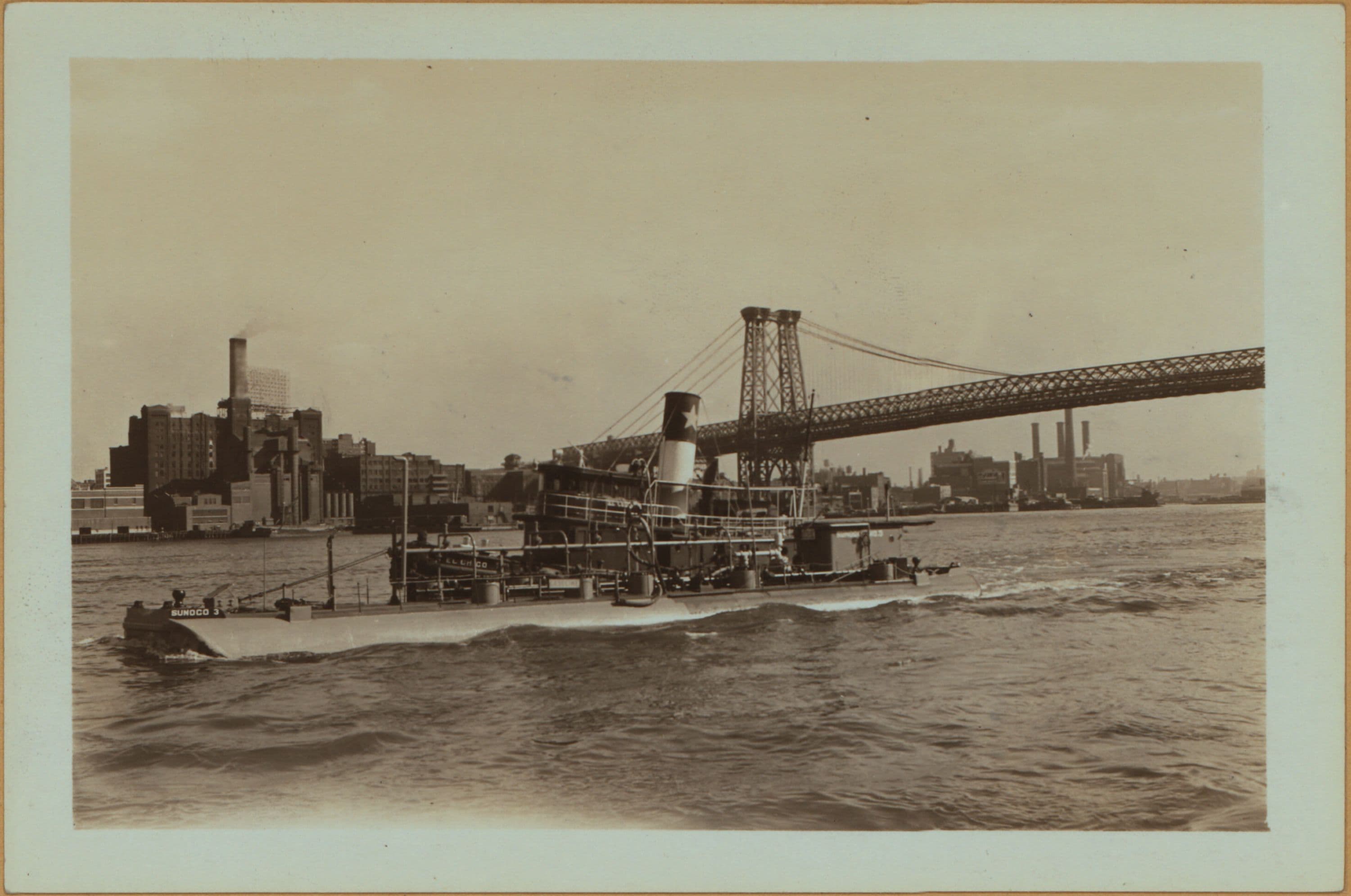 Bridges - Williamsburg Bridge [spans the East River, beginning at Delancey Street in Manhattan and terminating in Williamsburg, Brooklyn - View of the Bridge, showing Tugboat El Chico; Oil barge Sunoco 3; Yacht North Star; Dredge barge.], 1930–1935