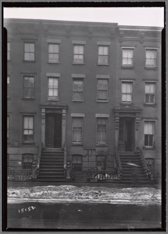 Brick row houses; H. Springer Plumbing: Clymer St. - Bedford Ave., Brooklyn