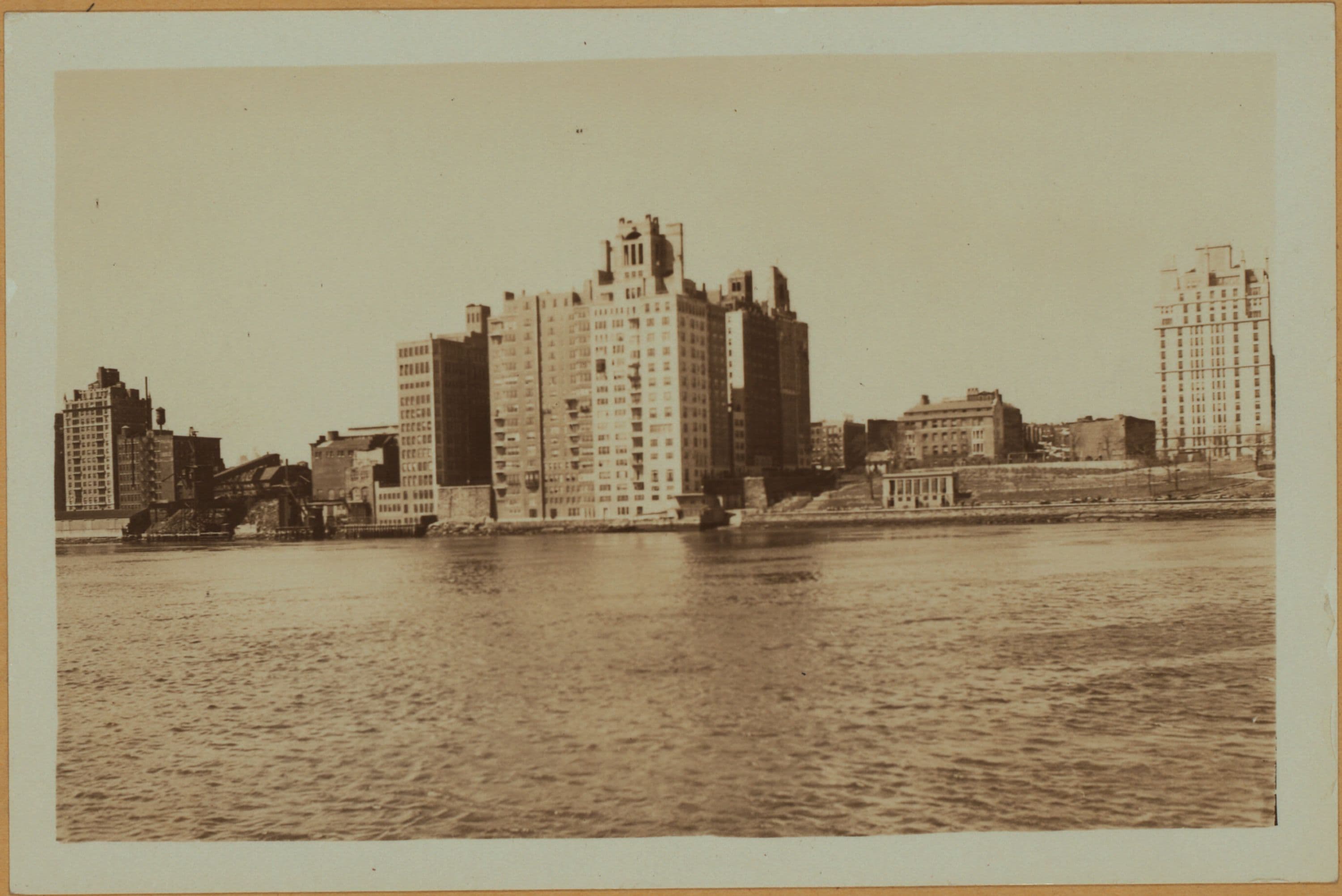 East River - Shore and skyline of Manhattan from East 85th Street - Queensborough Bridge - [Interboro Rapid Transit Building; New York Hospital; Yorkville Ice Sales Corporation.]