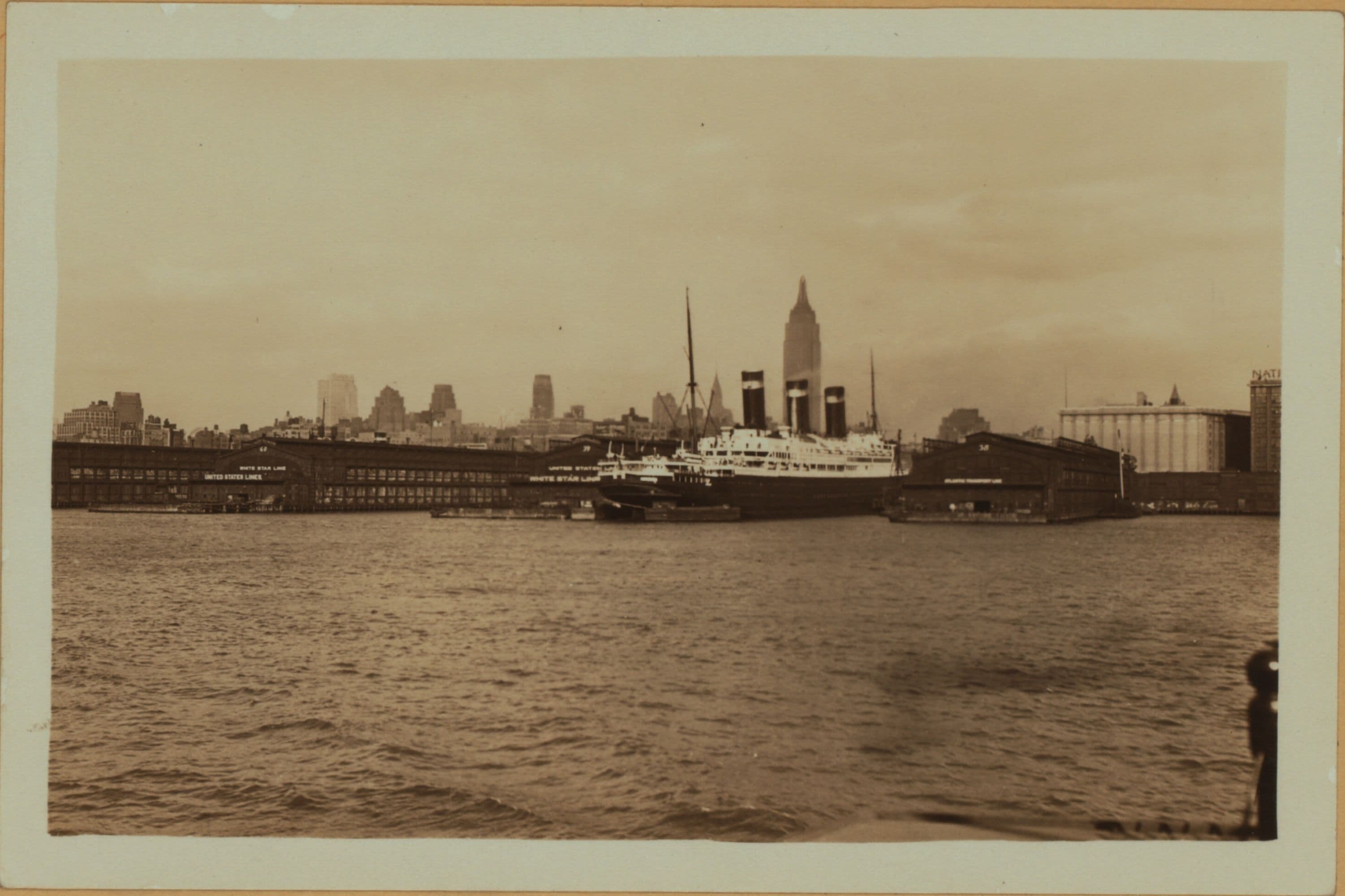 North (Hudson) River - Shore and skyline - Manhattan - [Midtown skyline between 14th and 59th Streets - Empire State Building - Piers 58, 59, 60 and 61 ; S. S. Leviathan.]