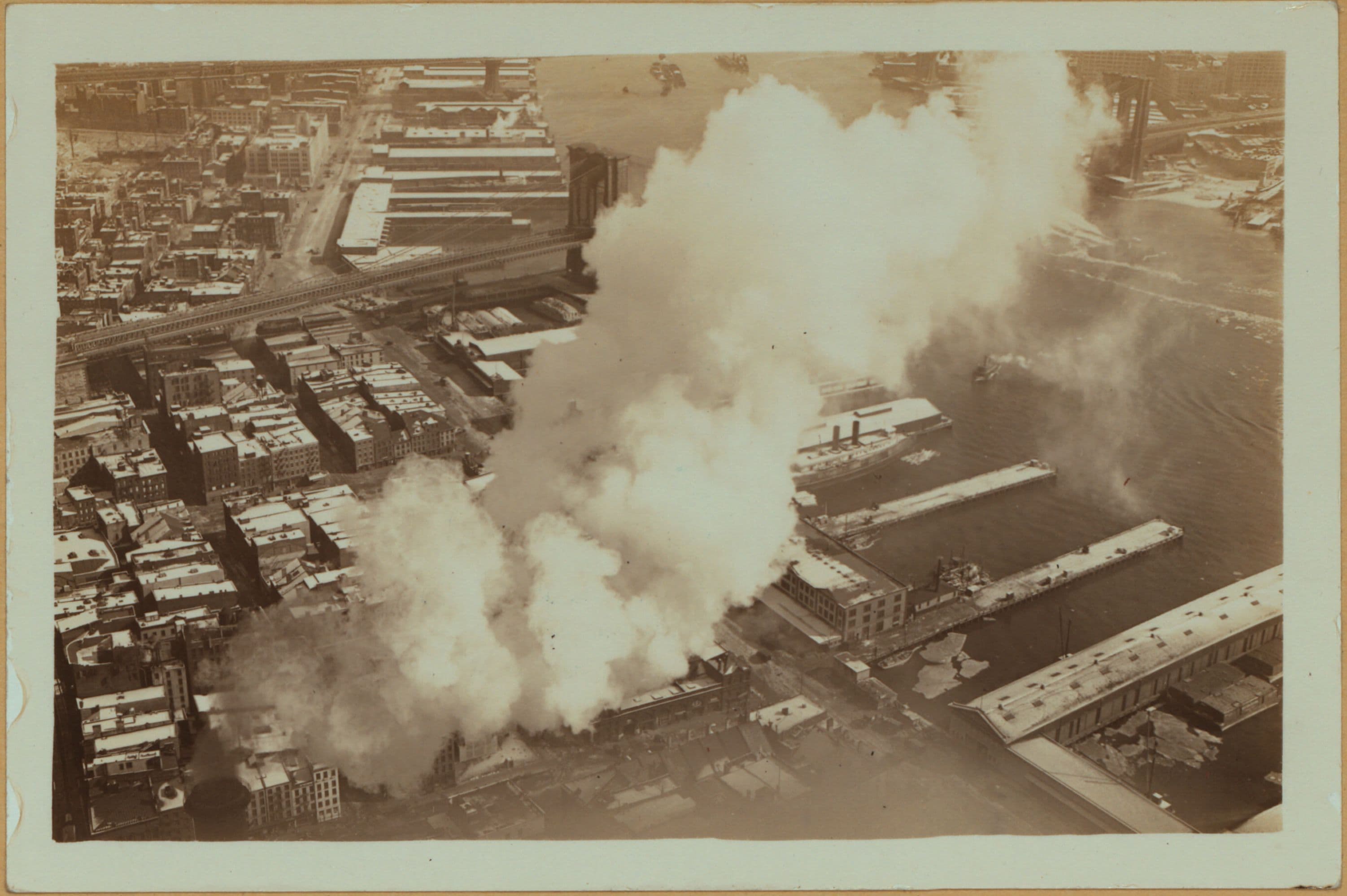 East River - Shore and skyline of lower Manhattan - South Ferry - Williamsburg Bridge - [New York Steam Company plant.]