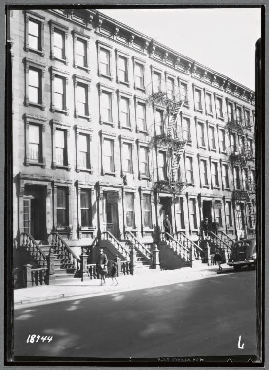 Brownstone row, residents on street and stoops: 75-81 E. 104th St-Park Av-Madison Av, Manhattan, 1938