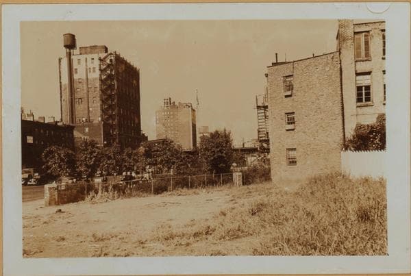 Manhattan: 6th Avenue - Minetta Street. Sixth Avenue, north from Minetta Street (right) and showing empty lots lining the east side of same. These were left when this southern extension of the Avenue was projected. The Sixth Avenue Elevated is seen making an eastward turn on West 3rd Street. In the distance appears the Empire State Building. This set of 3 views shows details of the same area., 1937-09-18